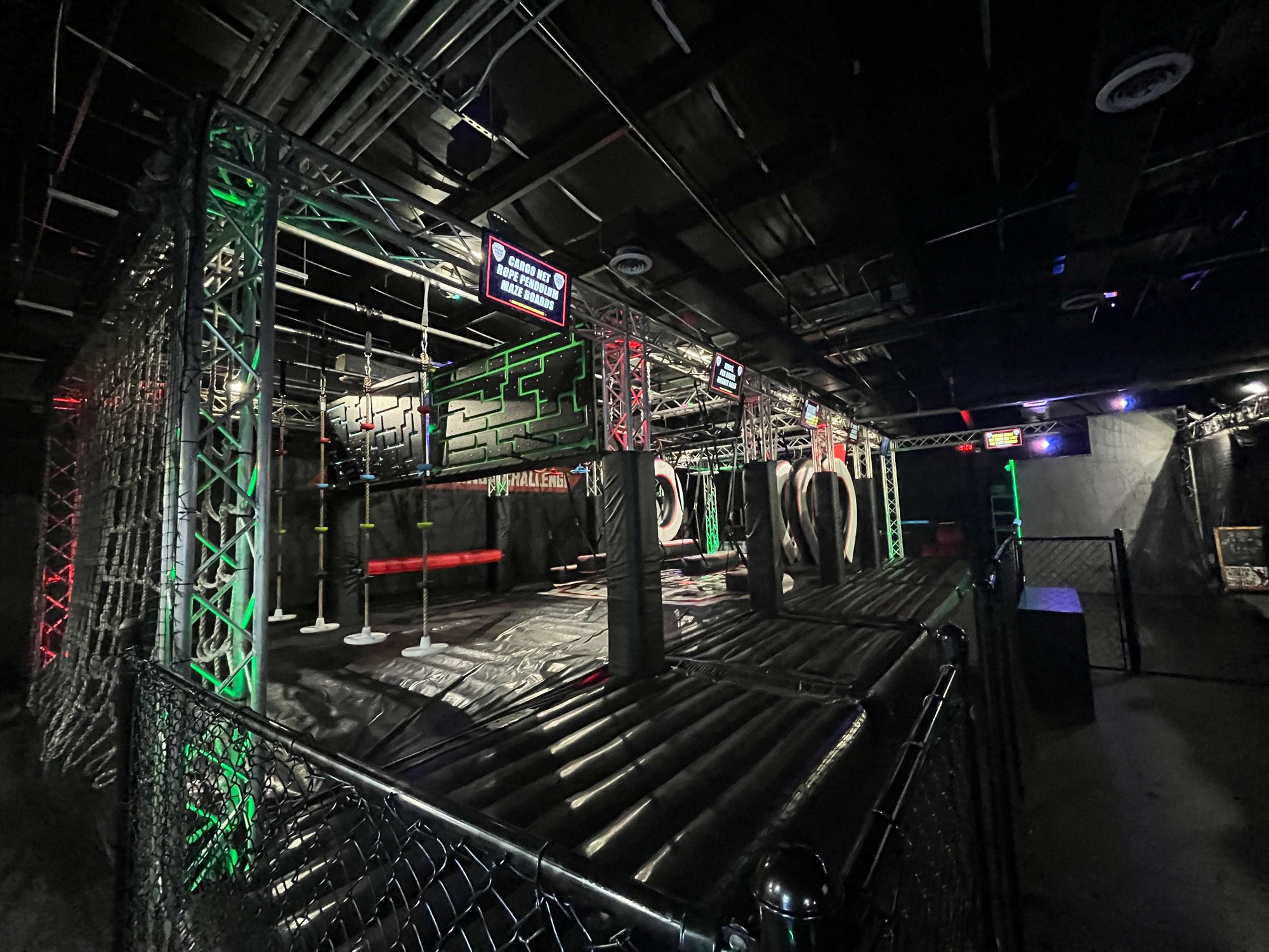 dark room with metal bars and obstacles for climbing